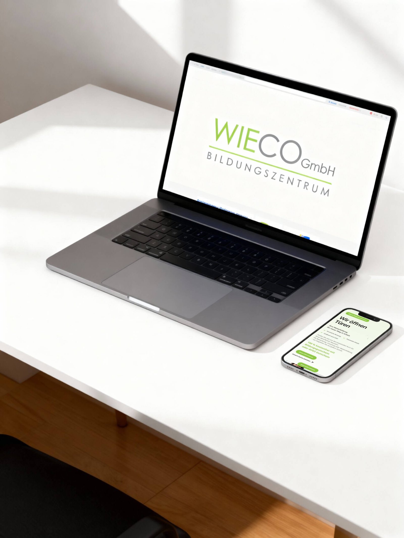 http://Laptop%20und%20Smartphone%20auf%20einem%20Schreibtisch,%20beide%20zeigen%20das%20Logo%20von%20WIECO%20GmbH%20Bildungszentrum.%20Der%20Laptop%20hat%20eine%20klare%20Bildschirmansicht,%20während%20das%20Smartphone%20eine%20mobile%20Webseite%20darstellt.